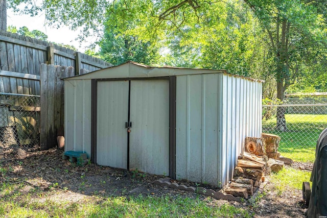 view of shed with a fenced backyard