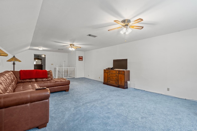 living area featuring a ceiling fan, carpet, visible vents, and lofted ceiling