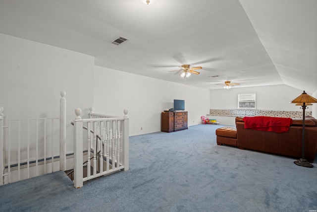 carpeted living area featuring lofted ceiling and visible vents