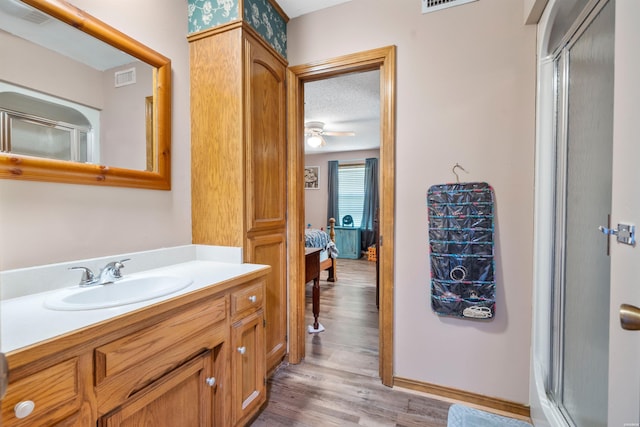 full bathroom featuring a stall shower, visible vents, connected bathroom, and vanity