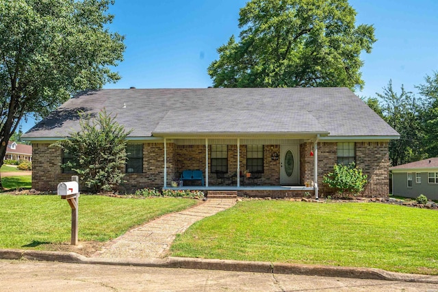 ranch-style home with a porch, brick siding, and a front lawn