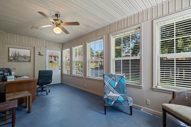 home office with ceiling fan, finished concrete floors, and baseboards