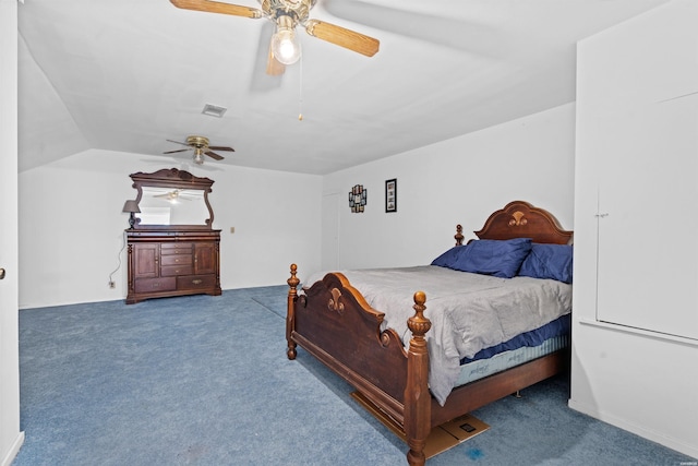 carpeted bedroom featuring ceiling fan, visible vents, and vaulted ceiling