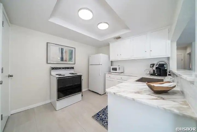 301 Kleinshore Rd Unit 17, Hot Springs, AR 71913 - kitchen featuring white appliances, a sink, white cabinets, a tray ceiling, and light stone counters