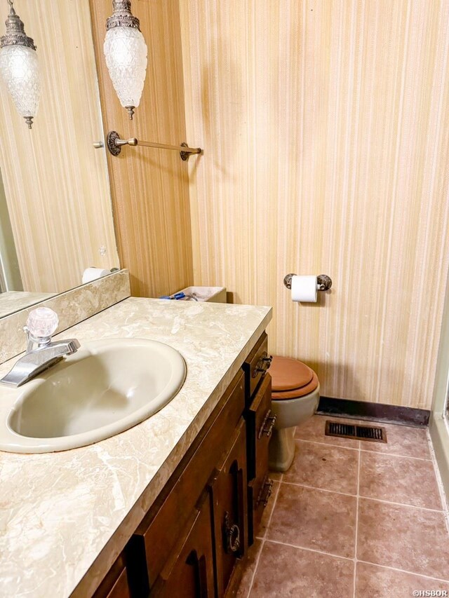 bathroom featuring toilet, tile patterned flooring, visible vents, and vanity