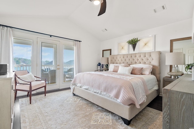 bedroom with a ceiling fan, wood finished floors, visible vents, vaulted ceiling, and access to outside