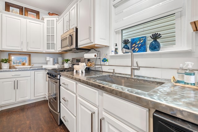 kitchen with a sink, dark wood-style floors, white cabinetry, and stainless steel appliances