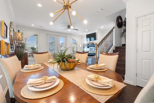 dining area featuring visible vents, ceiling fan with notable chandelier, wood finished floors, recessed lighting, and stairs