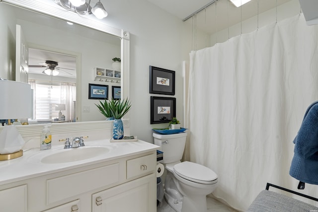 bathroom featuring toilet, ceiling fan, and vanity