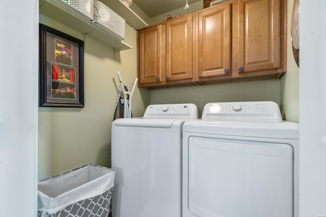 laundry room with cabinet space and washing machine and dryer