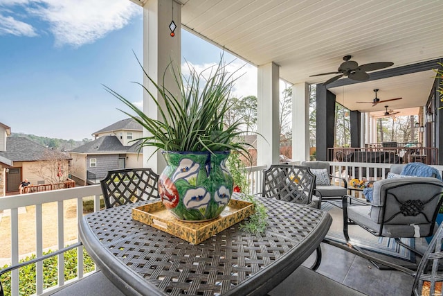 view of patio / terrace featuring outdoor dining space, a ceiling fan, and an outdoor hangout area