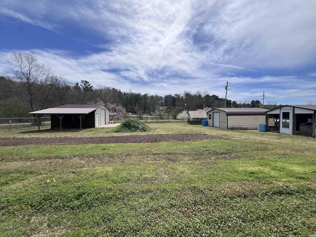 130,133,150 Treasure Isle Road, Hot Springs, AR 71913 - view of yard featuring an outbuilding, an outdoor structure, a carport, and fence