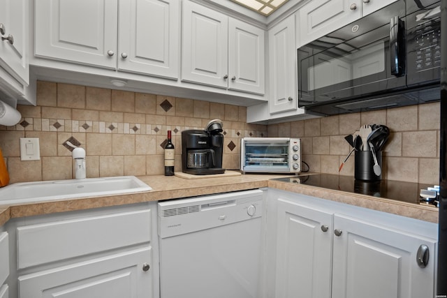 kitchen featuring black appliances, decorative backsplash, white cabinets, and light countertops