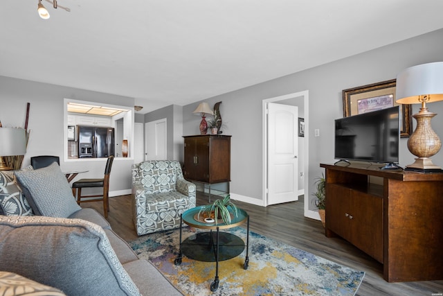 living room featuring dark wood-style floors and baseboards