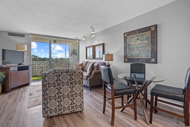 740 Weston Rd # 506, Hot Springs, AR 71913 - living area featuring expansive windows, visible vents, and wood finished floors