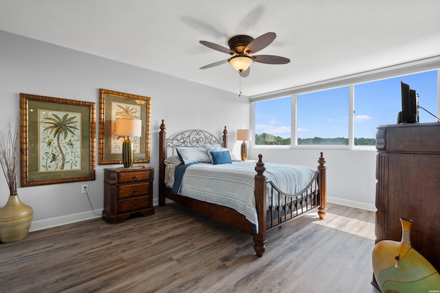 bedroom featuring dark wood-style floors, baseboards, and a ceiling fan