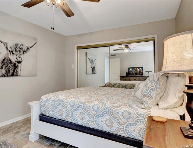 bedroom featuring ceiling fan, a closet, and baseboards