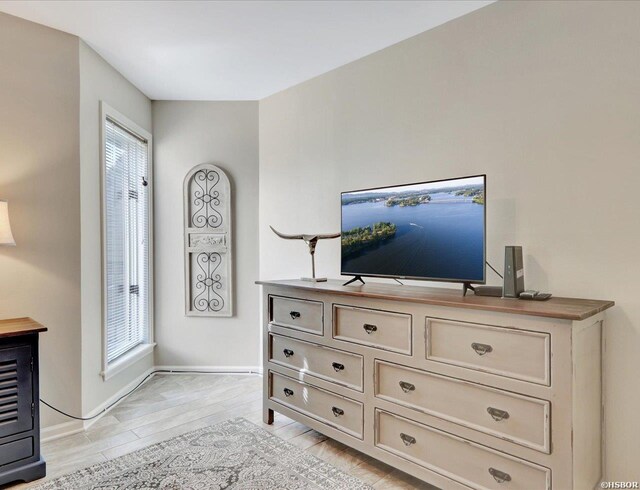 interior space with light wood-style floors and baseboards