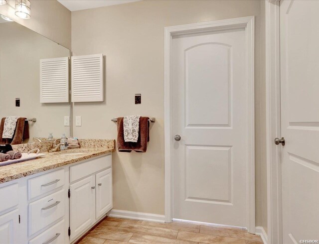 bathroom featuring vanity and baseboards