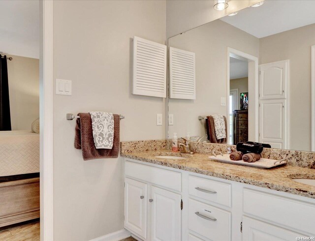 ensuite bathroom with ensuite bathroom, double vanity, and a sink