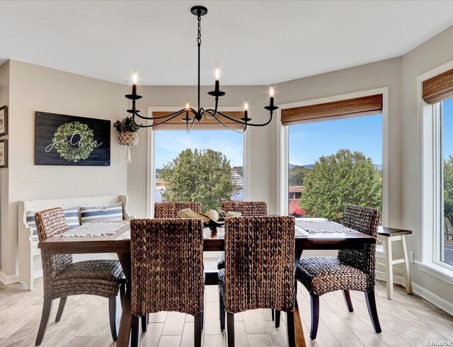 dining space with an inviting chandelier and baseboards