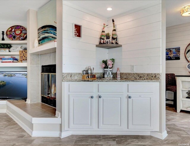 bar with a fireplace and wooden walls