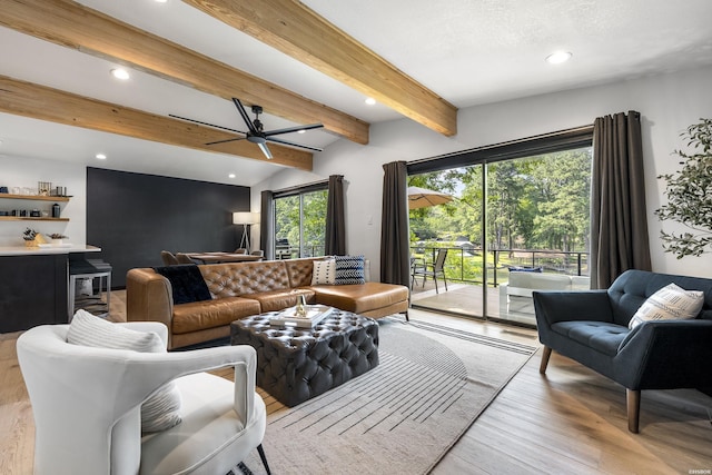 living area with recessed lighting, beam ceiling, light wood-style flooring, and a dry bar