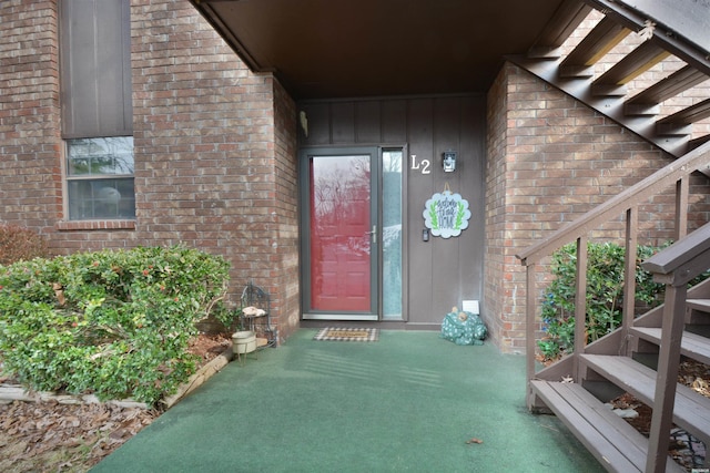 view of exterior entry with brick siding