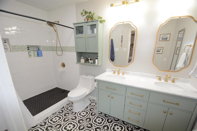 full bath with toilet, tiled shower, a sink, and tile patterned floors