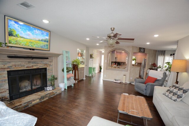 living area featuring ceiling fan, recessed lighting, a fireplace, visible vents, and dark wood-style floors