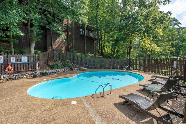 community pool featuring a patio area and fence