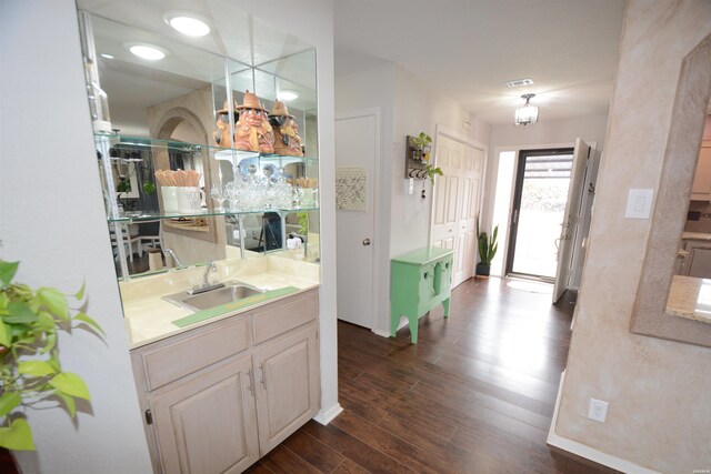 interior space featuring visible vents, dark wood finished floors, and baseboards