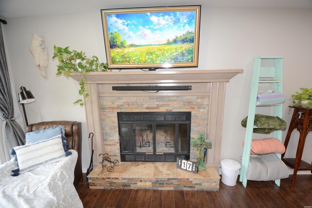 interior details featuring wood finished floors and a glass covered fireplace