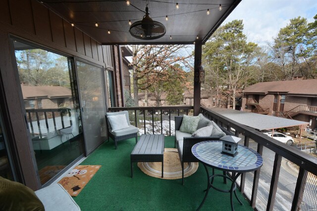 balcony with a ceiling fan and outdoor lounge area