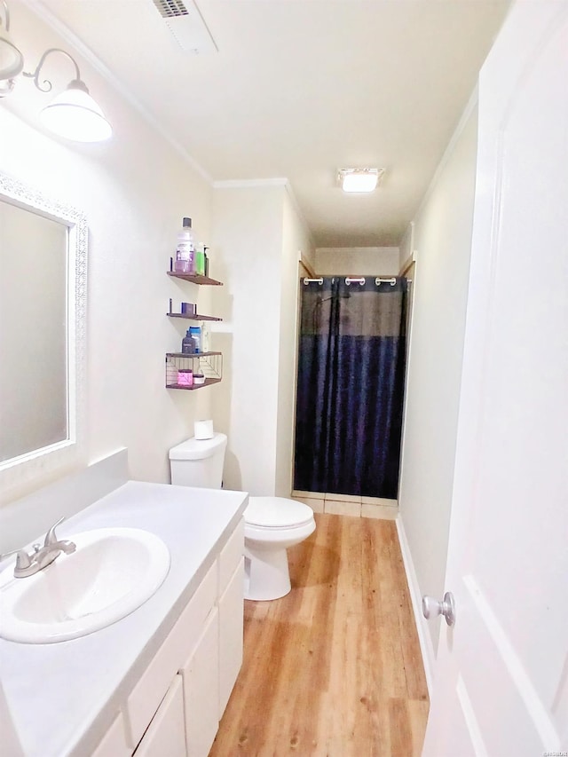 full bath with vanity, a shower with curtain, visible vents, toilet, and wood finished floors