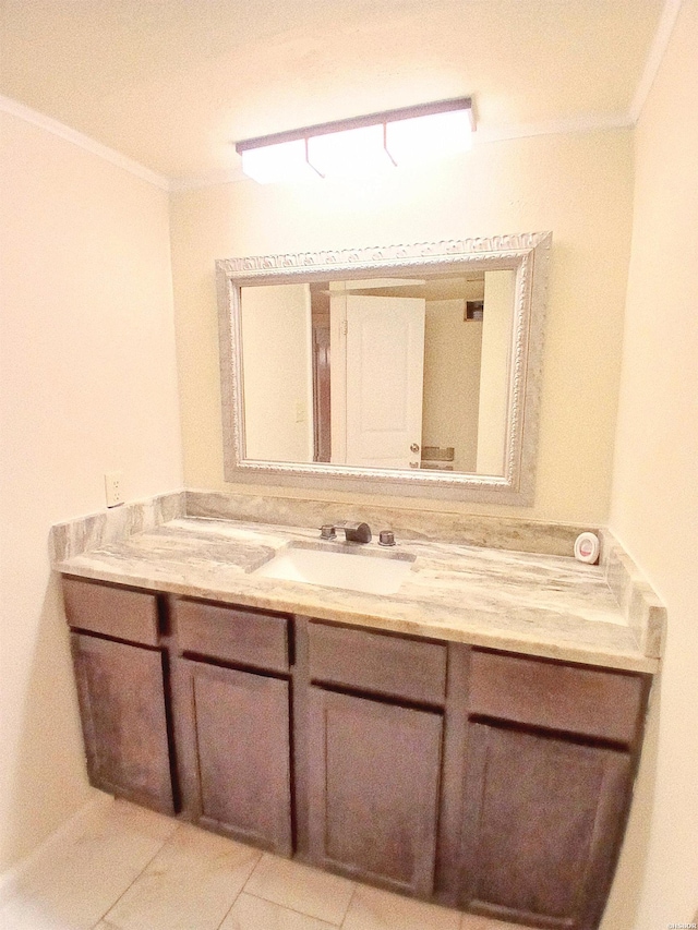 bathroom with crown molding, vanity, and tile patterned floors