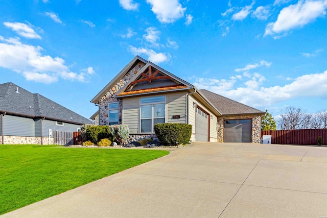 view of front of home featuring a garage, stone siding, fence, and a front lawn