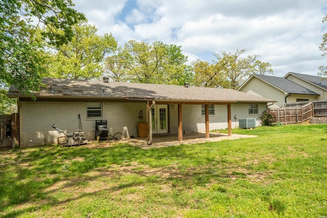 1204 Marion Anderson Rd, Hot Springs, AR 71913 - back of house featuring central air condition unit, a yard, a patio area, fence, and french doors