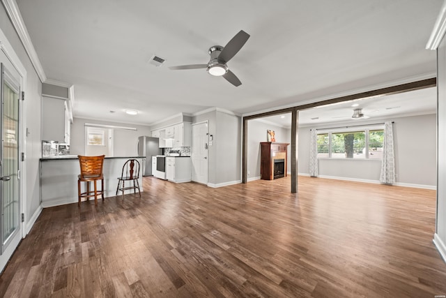 1204 Marion Anderson Rd, Hot Springs, AR 71913 - unfurnished living room featuring ceiling fan, a fireplace, crown molding, and dark wood-type flooring