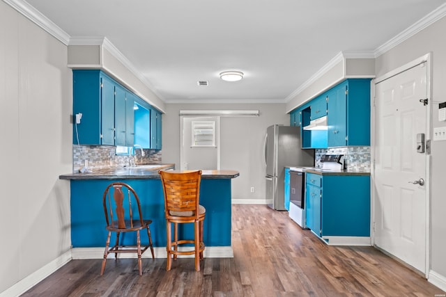 1204 Marion Anderson Rd, Hot Springs, AR 71913 - kitchen with electric range, under cabinet range hood, dark wood-type flooring, decorative backsplash, and blue cabinets