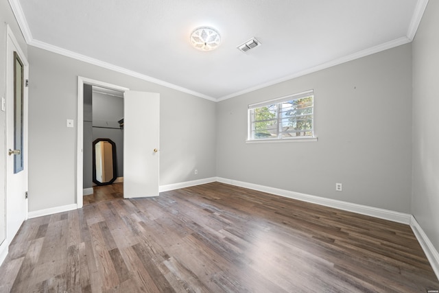 1204 Marion Anderson Rd, Hot Springs, AR 71913 - unfurnished bedroom featuring baseboards, ornamental molding, visible vents, arched walkways, and wood finished floors