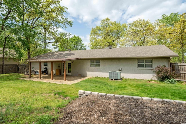 1204 Marion Anderson Rd, Hot Springs, AR 71913 - back of property with central air condition unit, a patio area, brick siding, a fenced backyard, and a yard