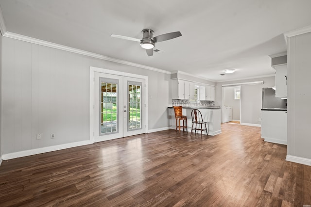 1204 Marion Anderson Rd, Hot Springs, AR 71913 - unfurnished living room with ornamental molding, dark wood-style floors, a ceiling fan, and french doors