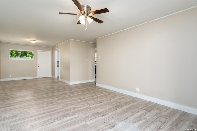 unfurnished room with light wood-style floors, baseboards, ornamental molding, and a ceiling fan