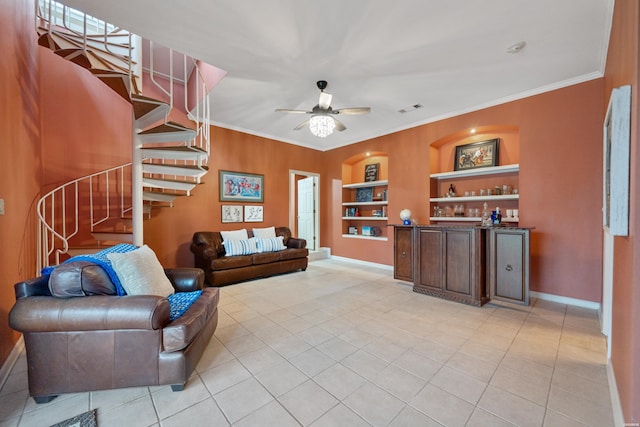 living area with built in shelves, visible vents, crown molding, and stairway