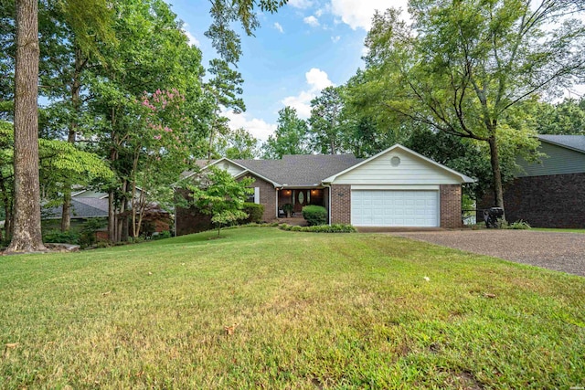 single story home featuring gravel driveway, brick siding, a garage, and a front yard