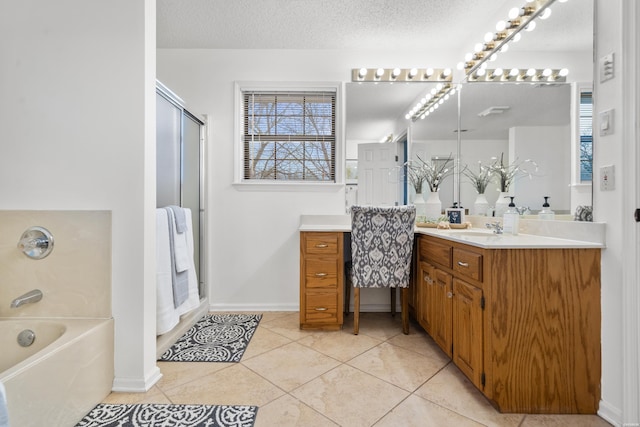 full bath with a bathtub, an enclosed shower, a textured ceiling, vanity, and tile patterned floors