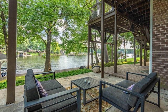 view of patio / terrace with a water view and stairs