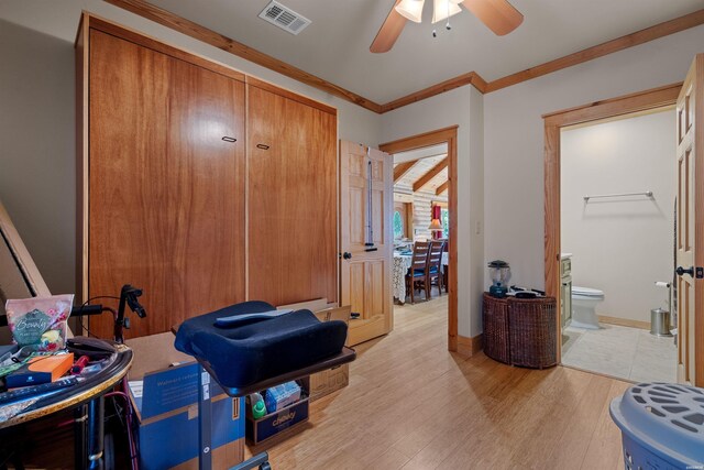 interior space featuring visible vents, light wood-style floors, ornamental molding, a ceiling fan, and baseboards