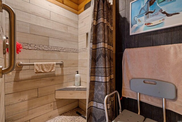 bathroom featuring wooden walls